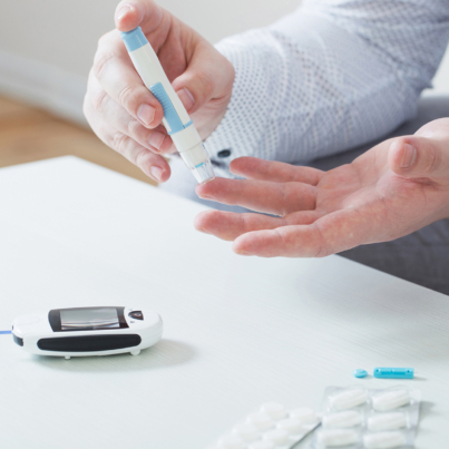 person measures blood sugar with glucometer