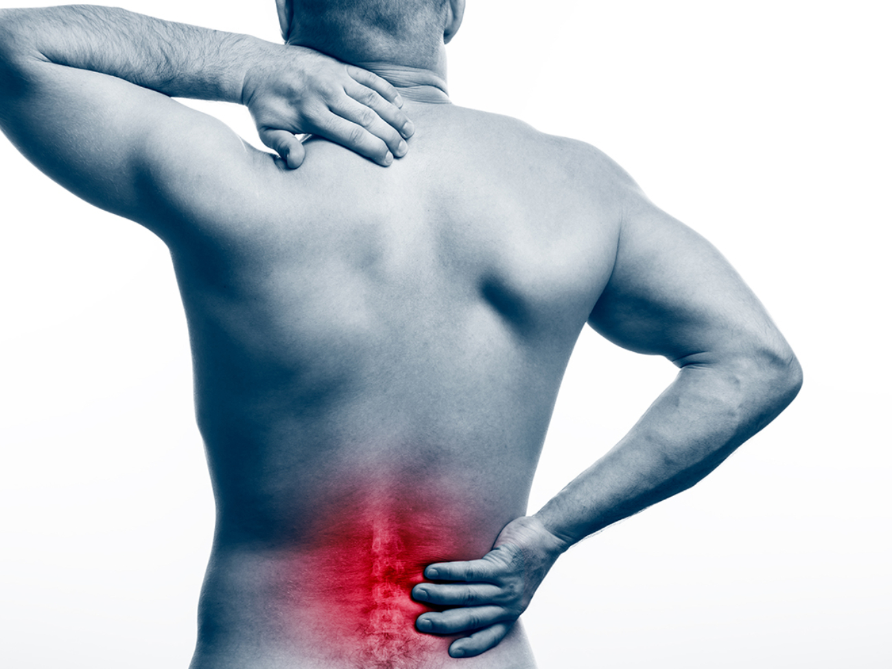 Pain in the spine.  Young bald man sports physique holds a sick back on a white isolated background. Fracture of spine