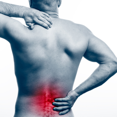 Pain in the spine.  Young bald man sports physique holds a sick back on a white isolated background. Fracture of spine